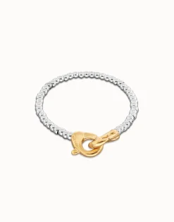 Pulsera de bolas pequeñas bañada en oro con mosqueton entrelazado en oro