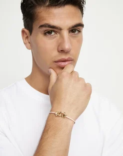 Pulsera de cuero rosa con mosquetón entrelazado en oro