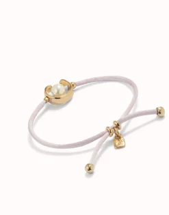 Pulsera de hilo lila con perla shell fornitura bañada en oro 18k.