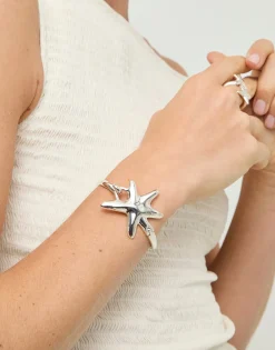 Pulsera rígida bañada en plata con estrella de mar
