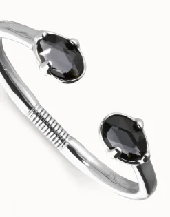 Pulsera rígida bañada en plata con dos cristales facetados ovalados negros